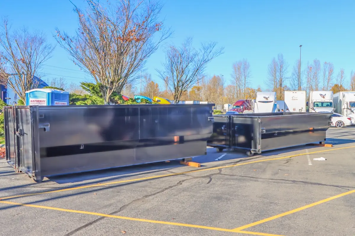 Professional dumpster rental service with roll-off container on residential driveway in Wahiawa